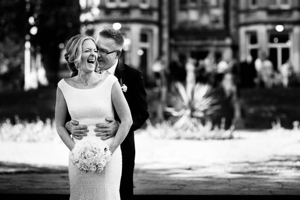 Photo of Bride and Groom laughing at Insole Court on their wedding day